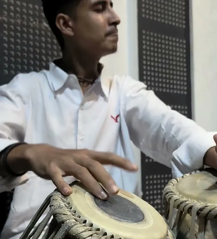 A student playing tabla at ECA Academy