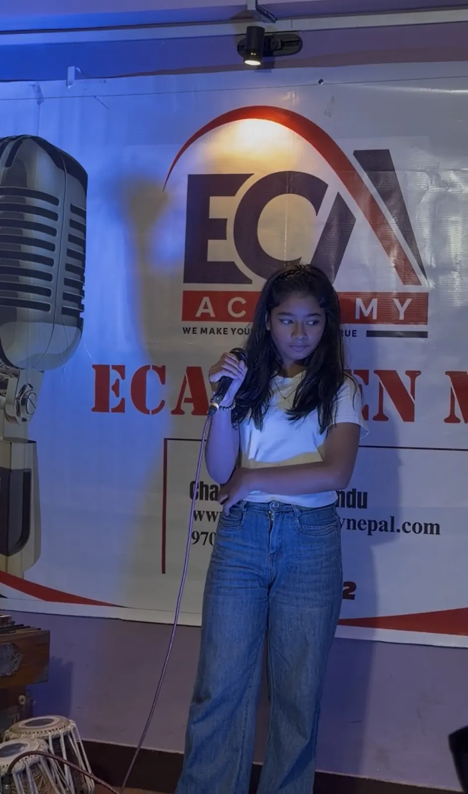 A student singing at ECA Open Mic