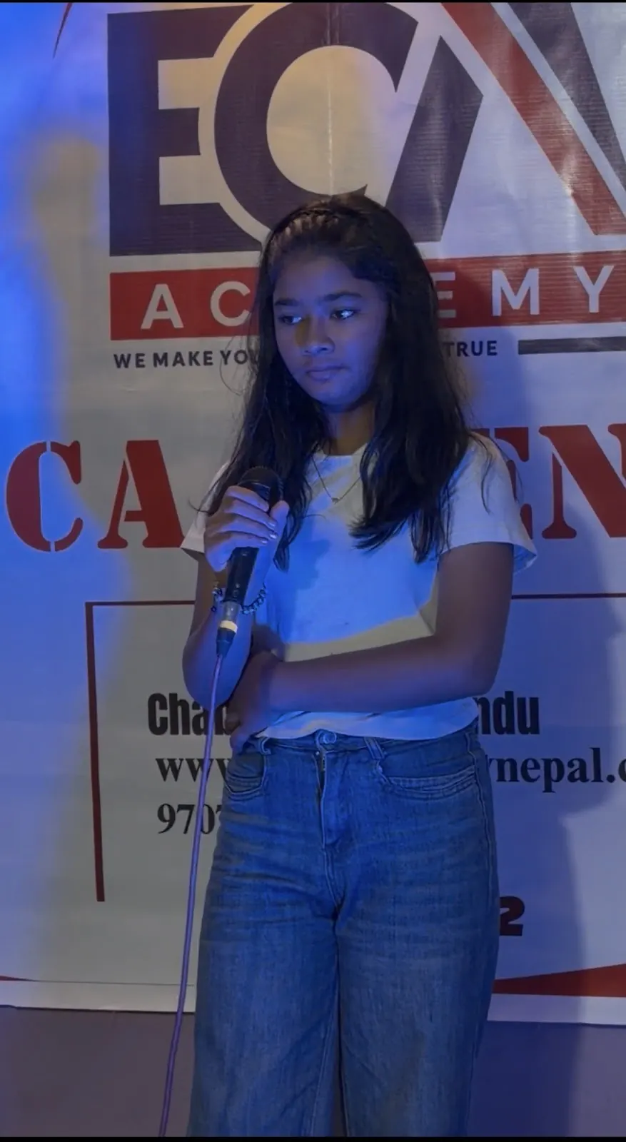 A student singing at ECA Open Mic