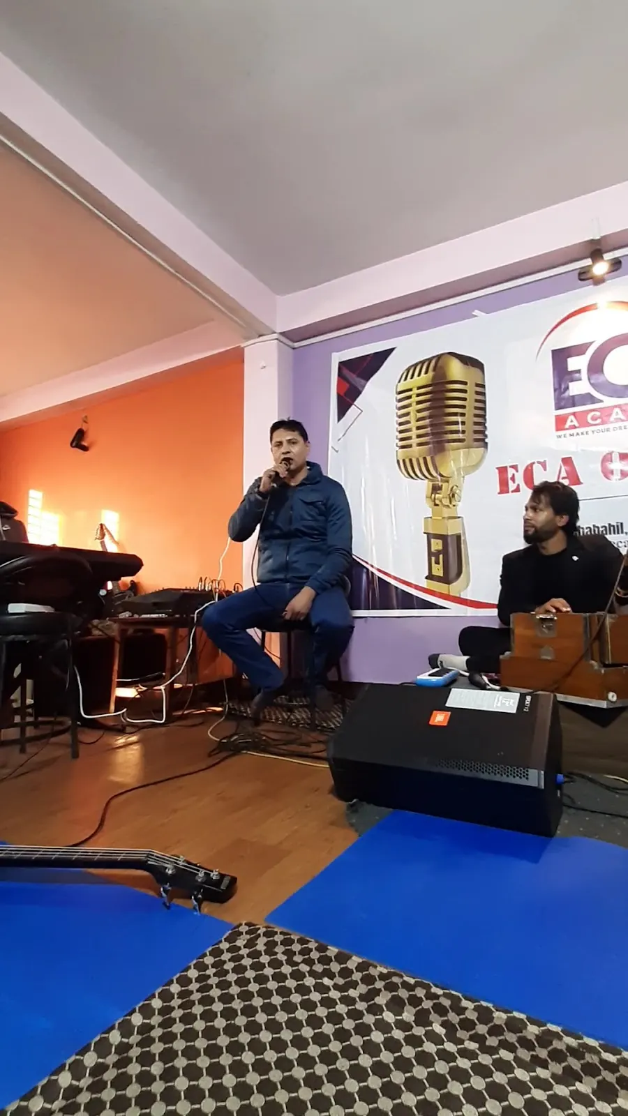 A student singing with a guitarist at ECA Academy