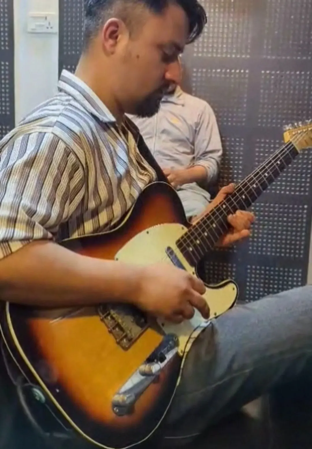Guitar instructor Rizol Pokhrel playing electric guitar