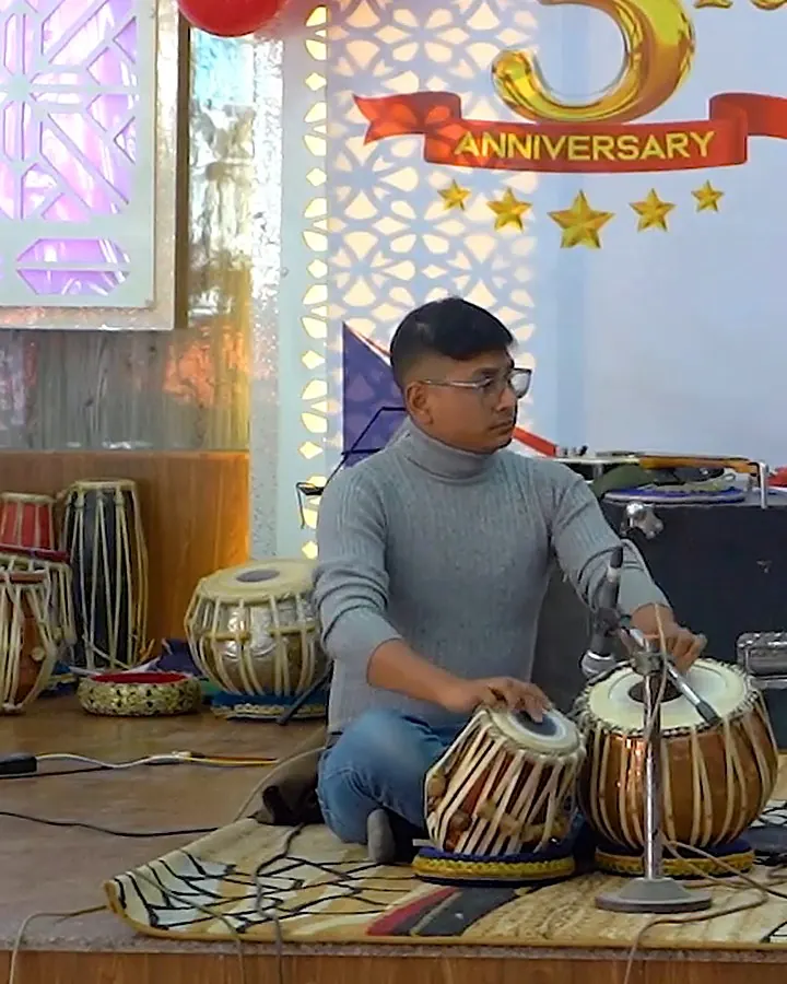 Jagannath Dhaugoda playing tabla on stage