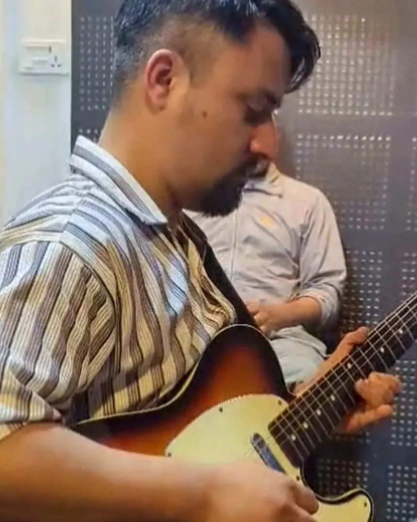 Rizol Pokhrel playing electric guitar